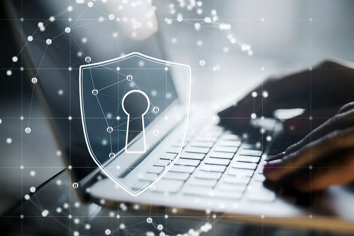 close up backlit female hands using laptop keyboard with abstract glowing padlock shield inside polygonal sphere blurry background secure protection safety concept double exposure Kopie